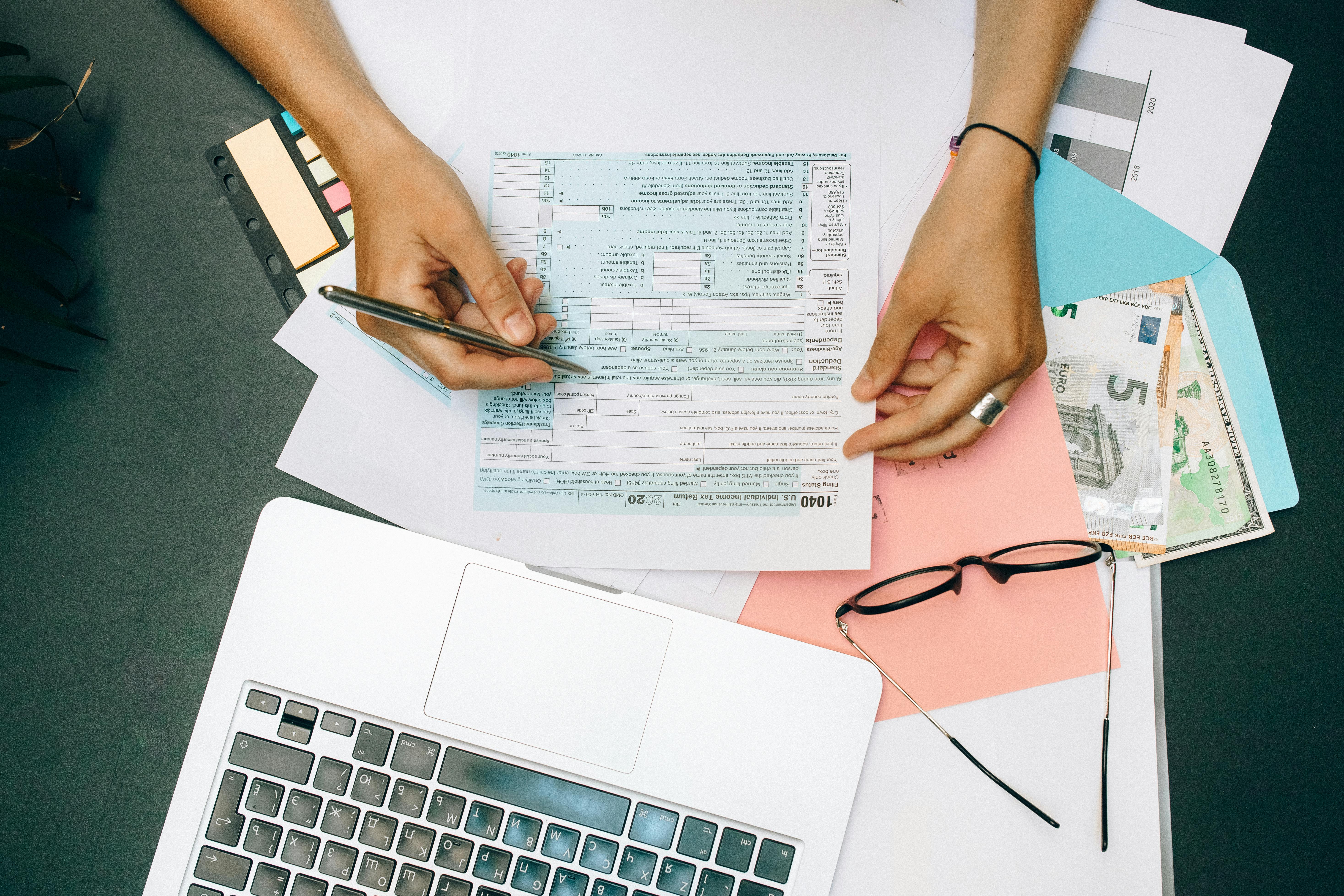 Woman filling tax documents | Source: Pexels