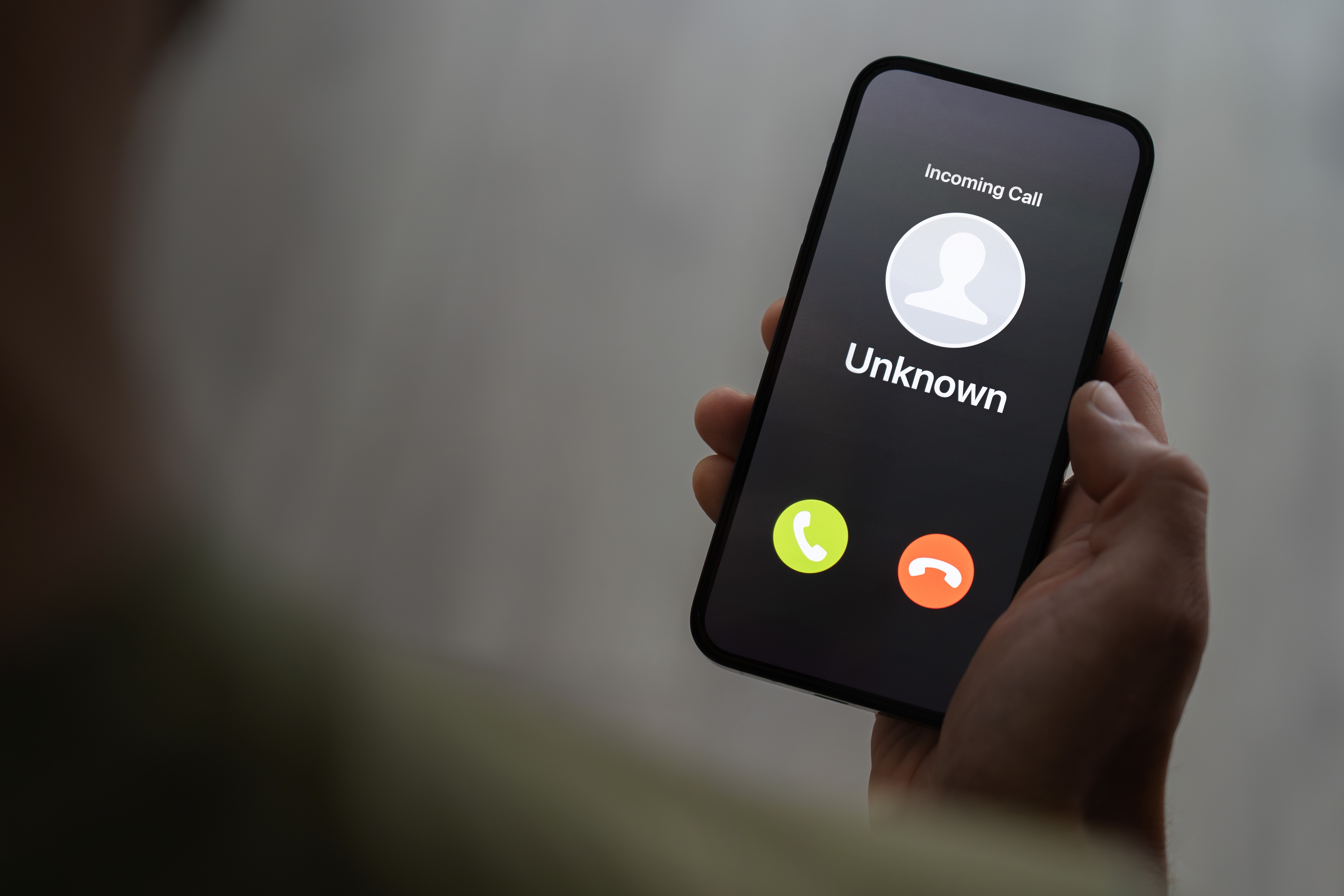 Person holding ringing phone with unknown caller. | Source: Shutterstock