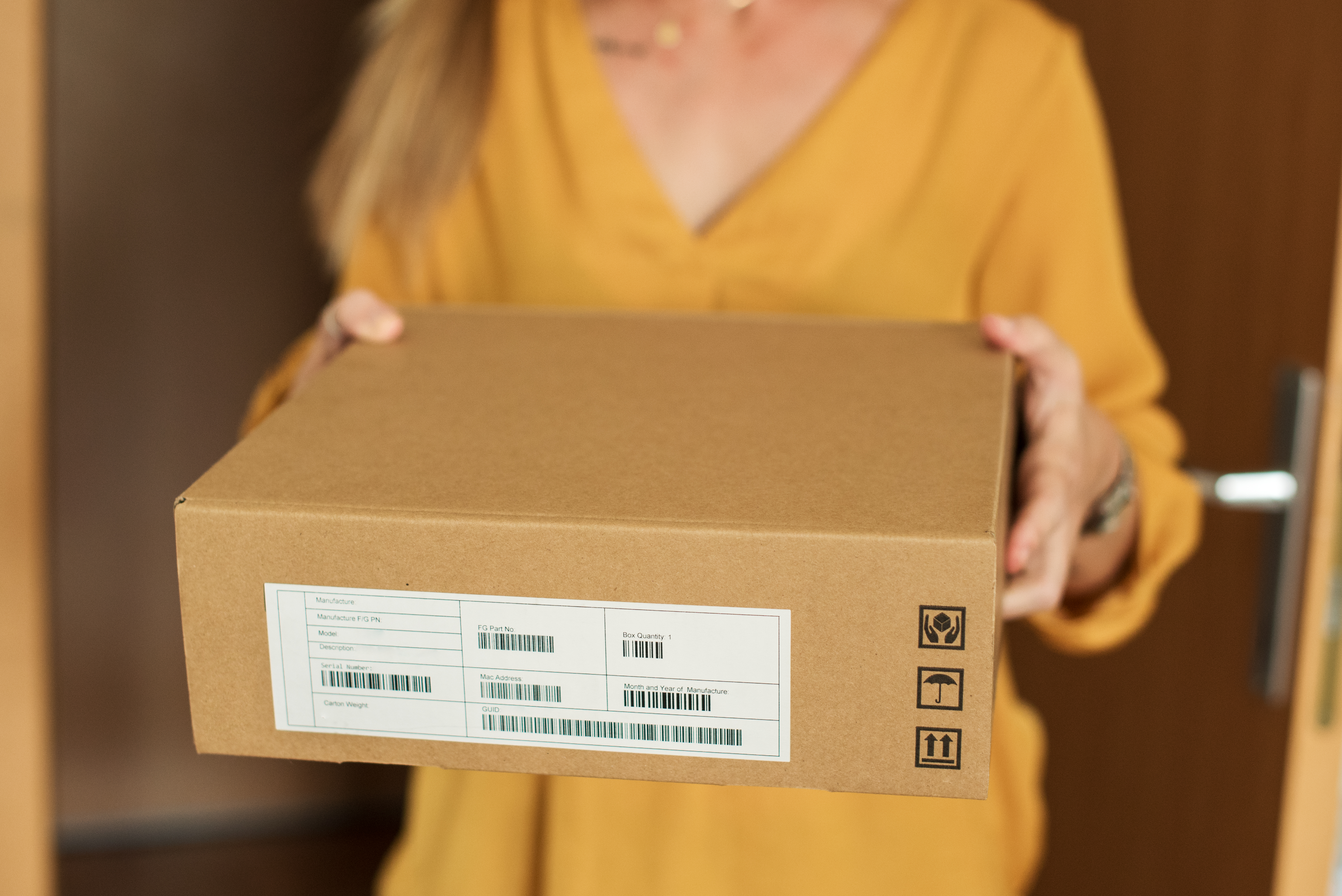 A woman receives a parcel | Source: Getty Images