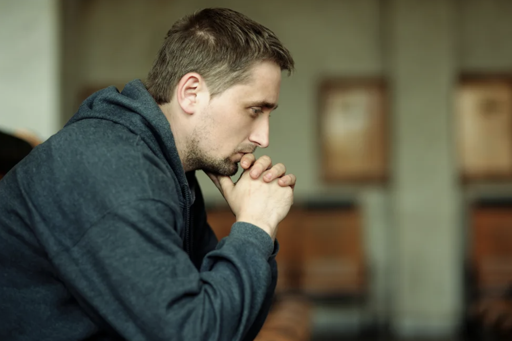 Sad man is sitting on the bench | Source: Shutterstock.com