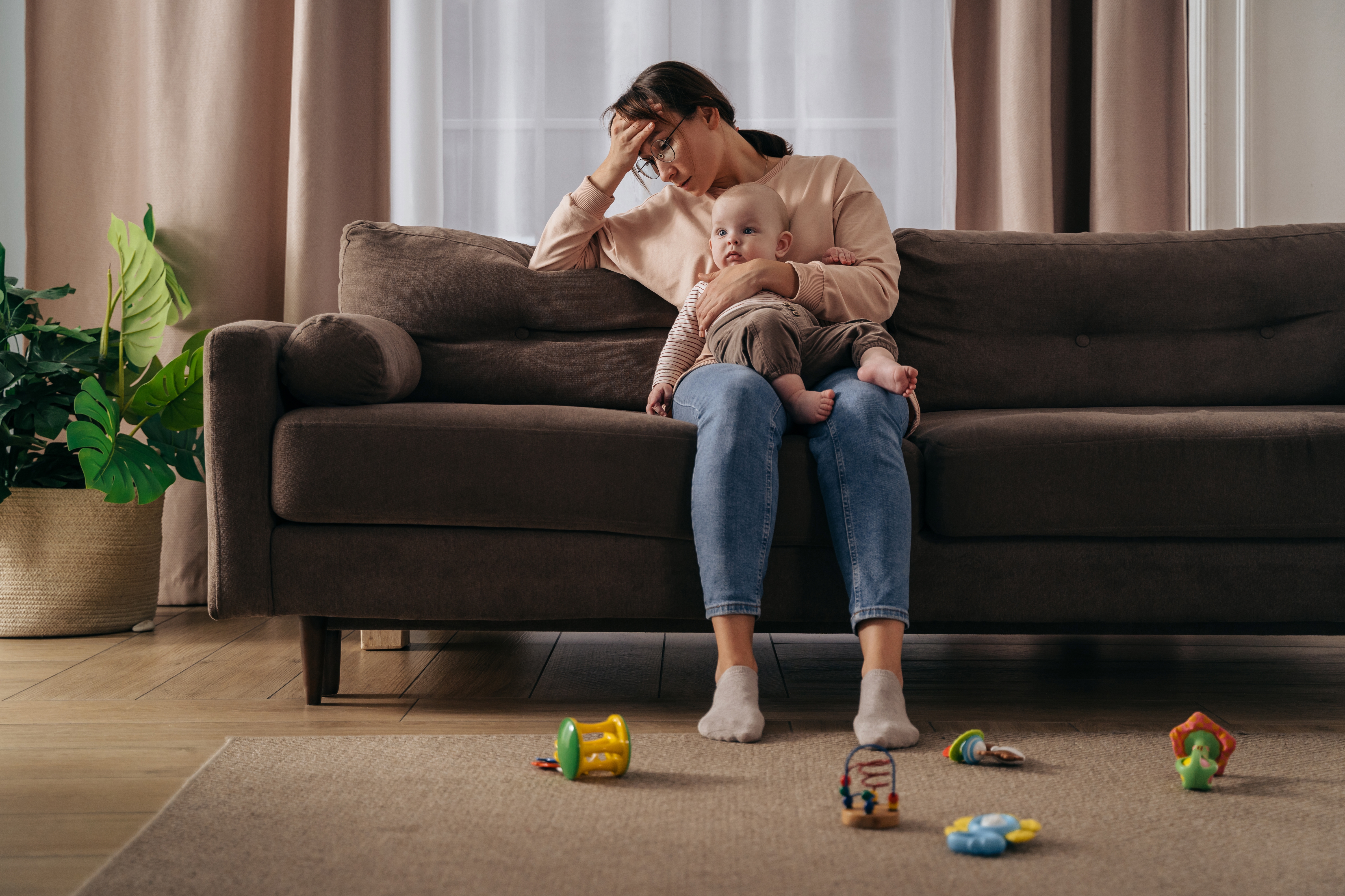 A stressed mother holding a baby | Source: Shutterstock