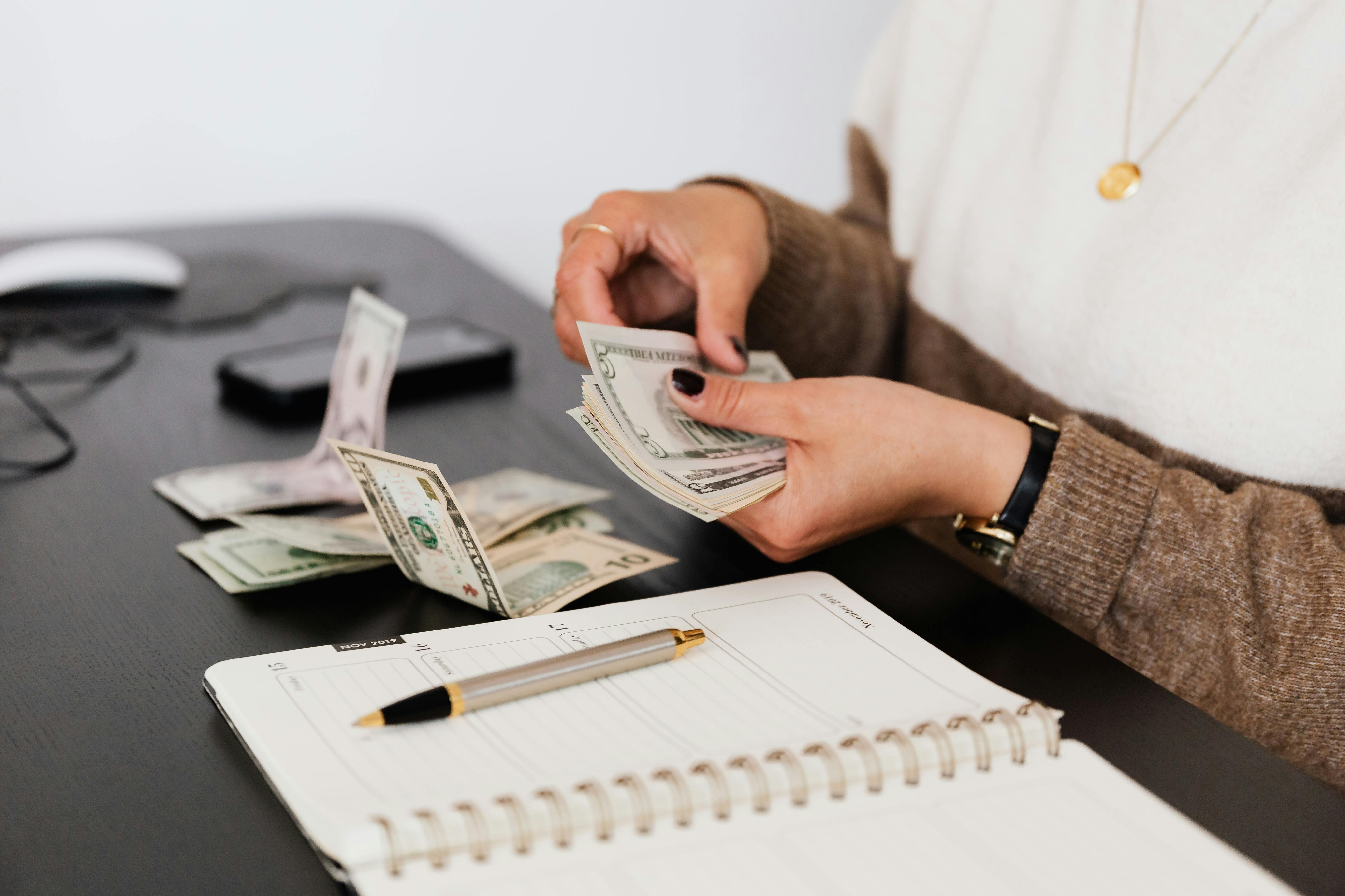 Person counting money | Source: Pexels