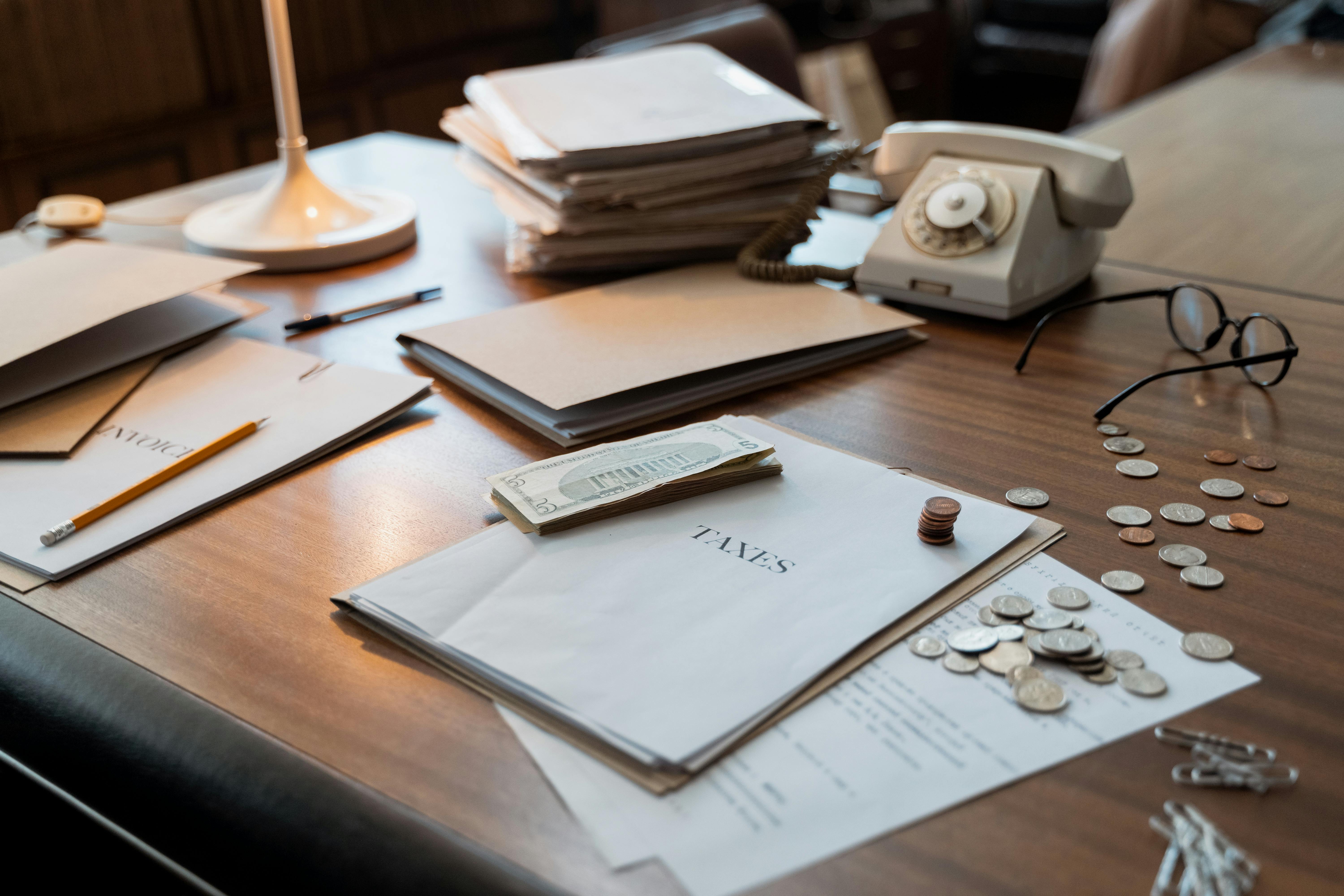 Desk with tax papers and money | Source: Pexels