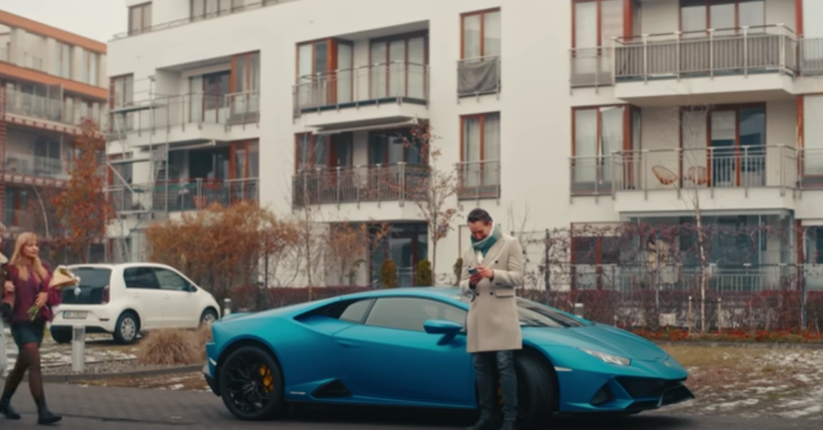 Man stands next to a luxury car | Source: Youtube/DramatizeMe