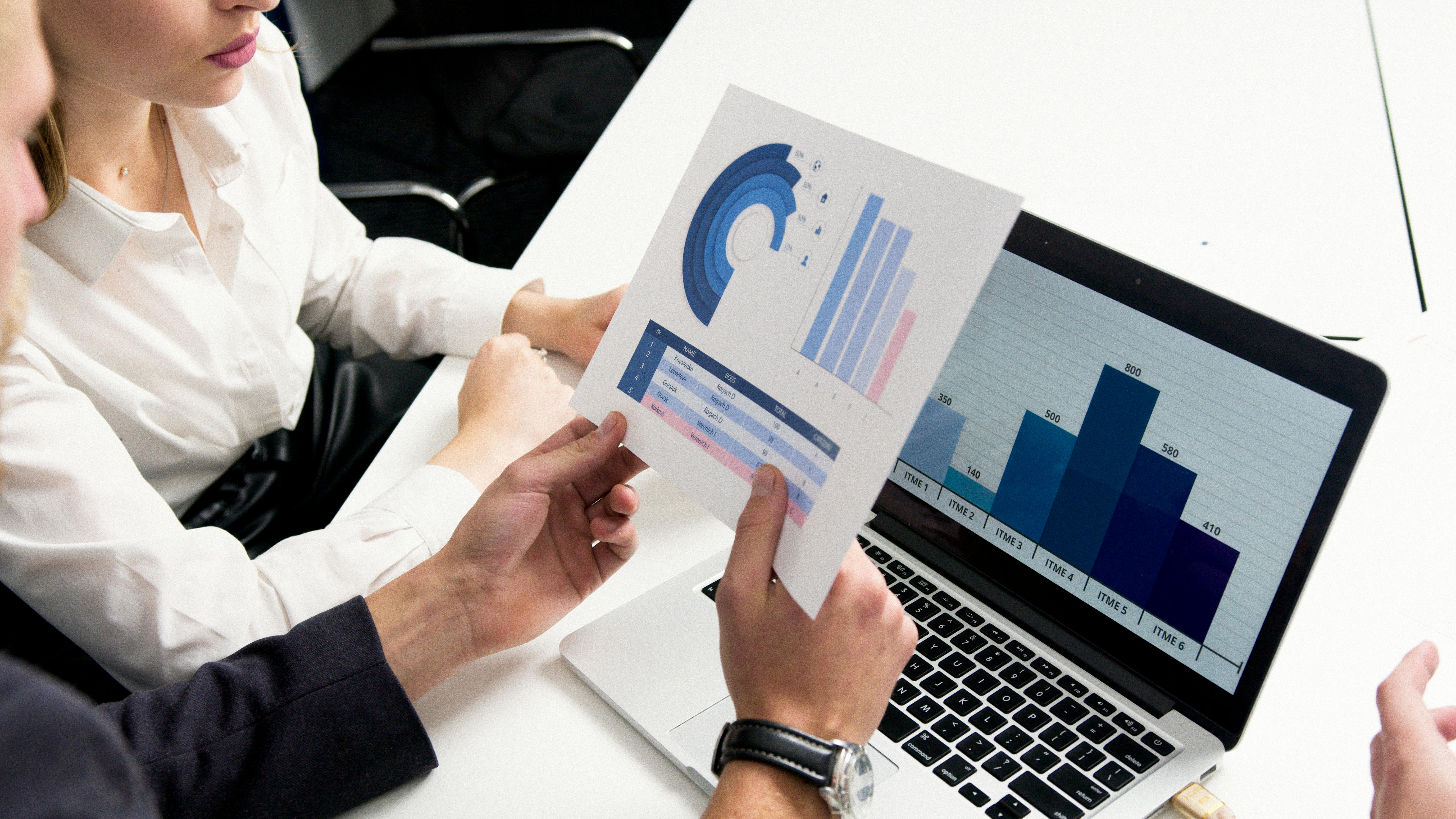 People reviewing charts and graphs | Source: Pexels