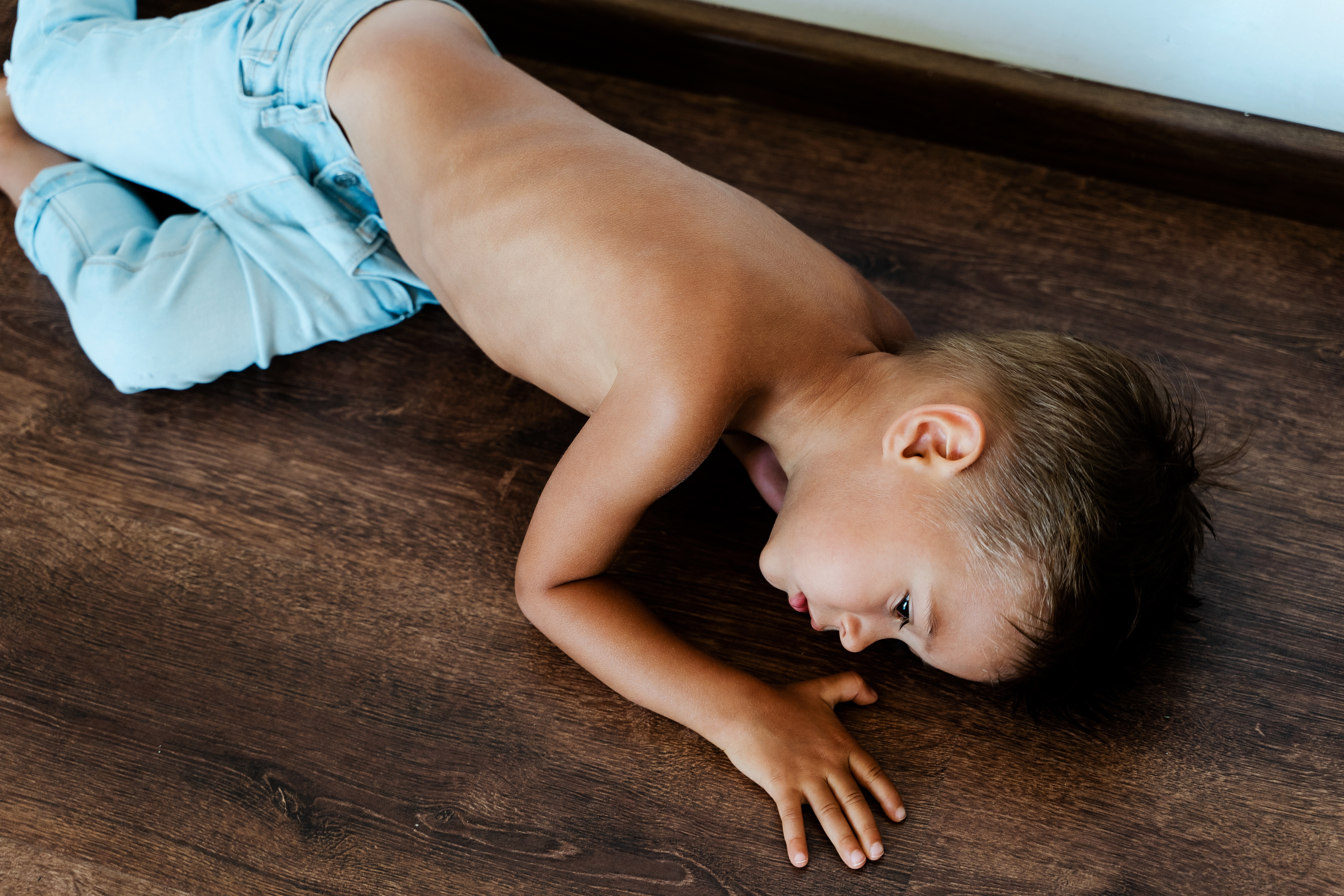Sad little boy lying on the floor | Source: Shutterstock
