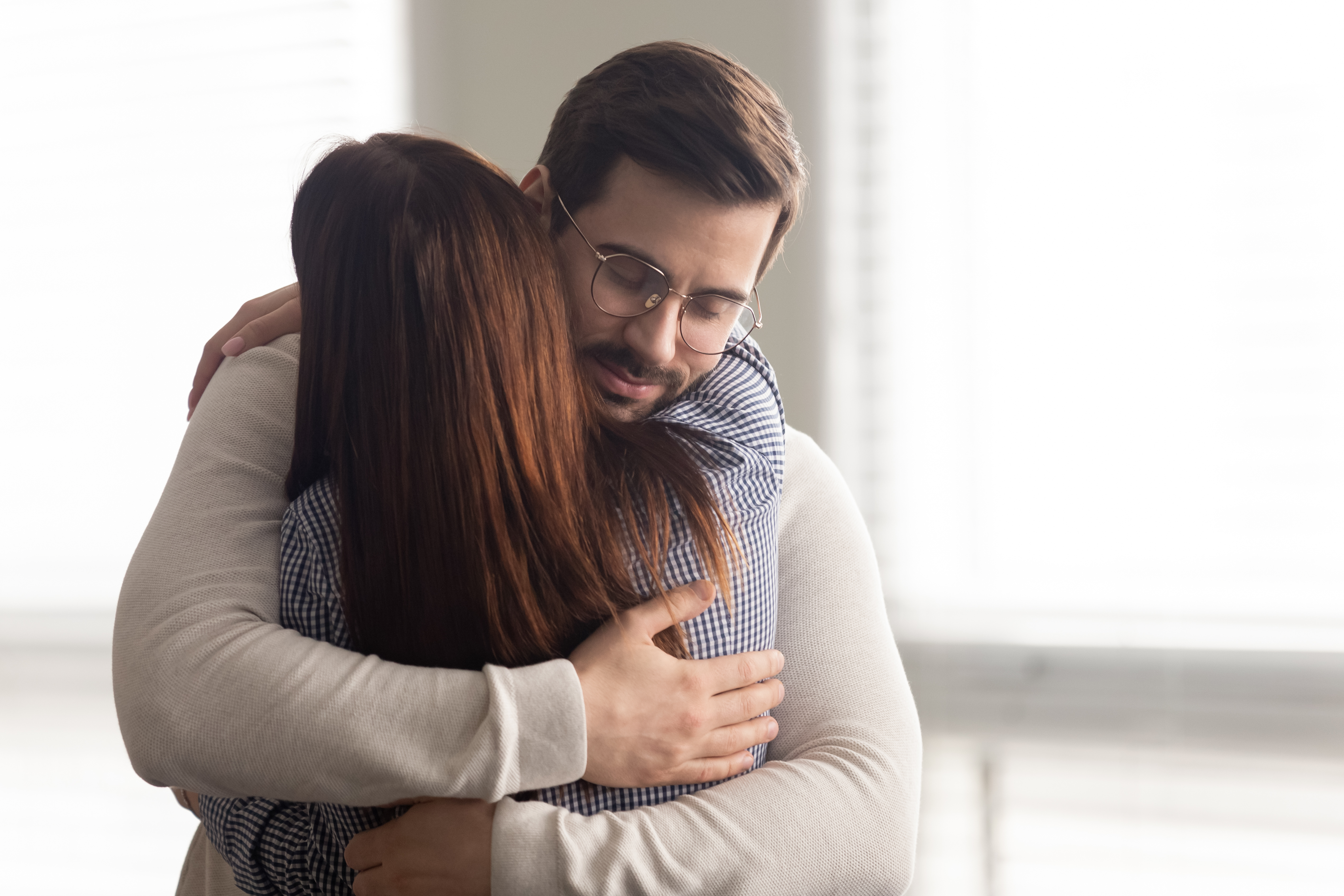 Man hugs sad woman | Source: Shutterstock.com